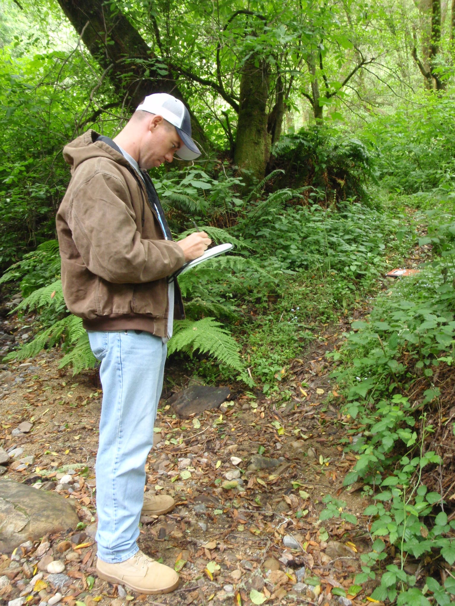 MAJ Frank Harmon takes field notes in the Santa Cruz Mountains, CA before collecting GPS data and LiDAR points