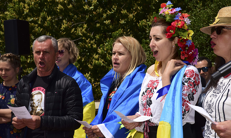The Ukrainian delegation sings their national anthem during International Day, returning after a two-year hiatus to the NPS campus, May 7. 