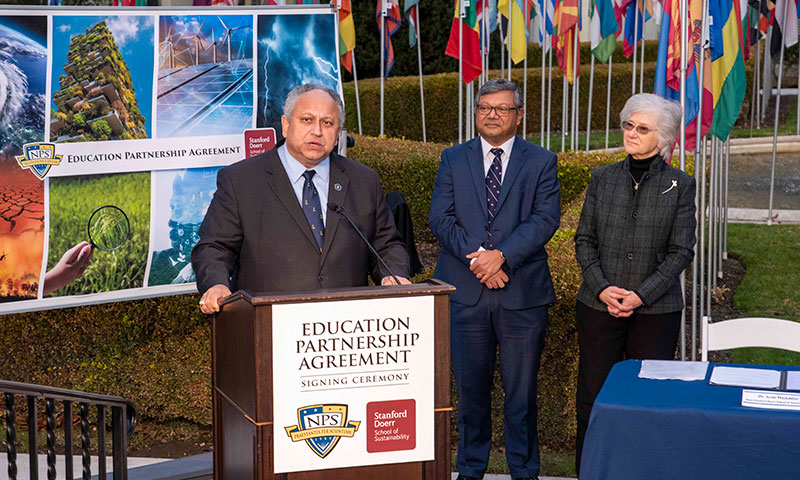 Secretary of the Navy Carlos Del Toro, Retired Vice Adm. Ann Rondeau, and Dr. Arun Majumdar, dean of the Stanford Doerr School of Sustainability, at signing ceremony. 