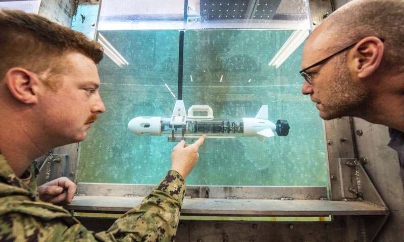 U.S. Navy Lt. James Dubyoski and NPS assistant professor Tony Pollman conduct testing on the Disposable Reusable Expeditionary Warfare Underwater Vehicle